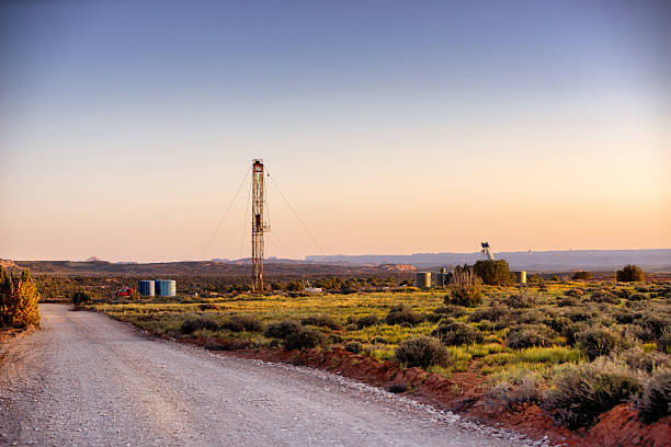 Drilling Fracking Rig in the Desert Drilling Fracking Rig in the Southwest desert at sunset natural gas extraction stock pictures, royalty-free photos & images