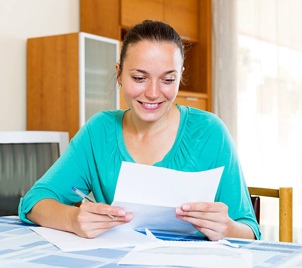 istock girl filling out tax forms 488501704