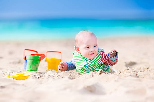 istock Funny baby playing on the beach 488501839