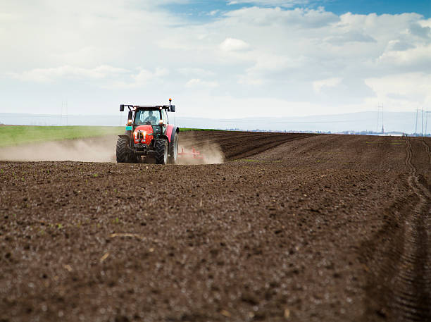 istock Farmer in tractor preparing land for sowing 488502135