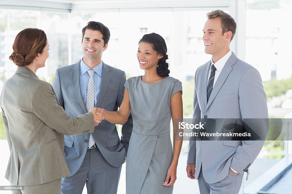 Business team meeting their partner Business team meeting their partner in the office Businesswear Stock Photo