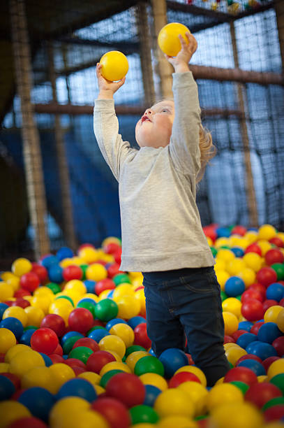 Young girl playing in a ball pool stock photo