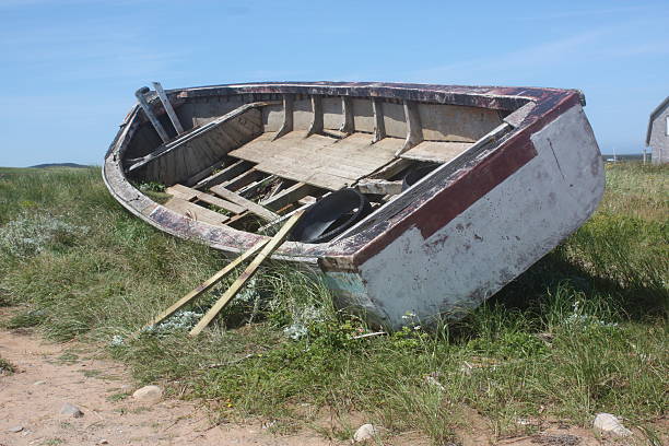 A boat lies abandoned on a beach on Magdalen Islands.