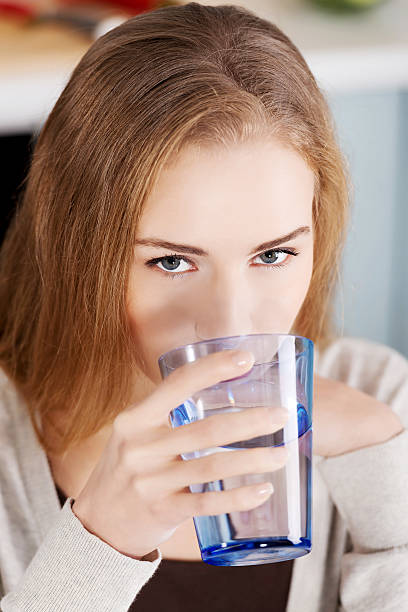 istock Beautiful woman drinking fresh water. 488504593