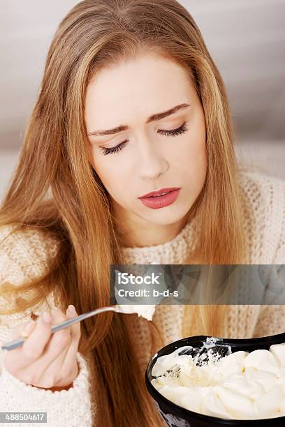 Young Depressed Woman Is Eating Stock Photo - Download Image Now - Sadness, Eating, Ice Cream