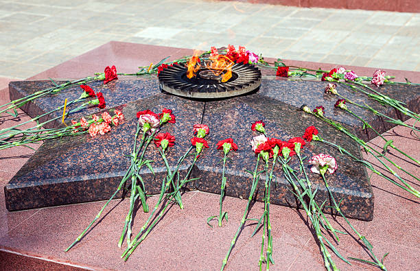 istock Eternal flame and flowers 488505402