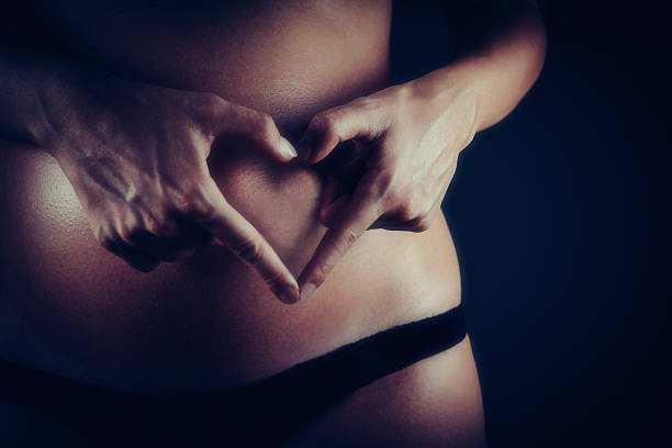 person posing in a studio environment with a dark background