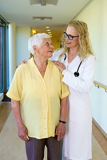 istock Nurse Talking to an Elderly Woman at the Corridor. 488507430
