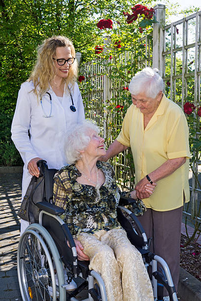 istock Doctor and Assistant Caring Elderly at the Garden. 488508434