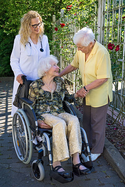 istock Elderly with her Doctor Talking to Caregiver. 488508568