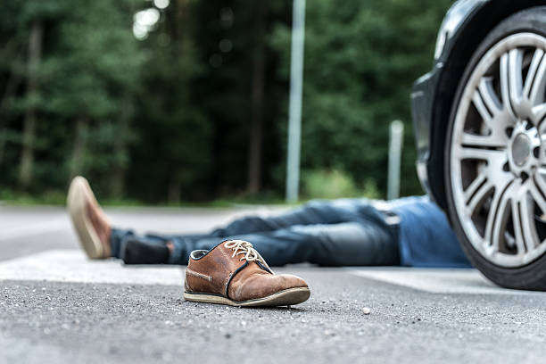 Car hit scene Male person got hit by a car, focus on shoehttp://shrani.si/f/3i/z0/3l6ClGqd/untitled-1.jpg pedestrian stock pictures, royalty-free photos & images