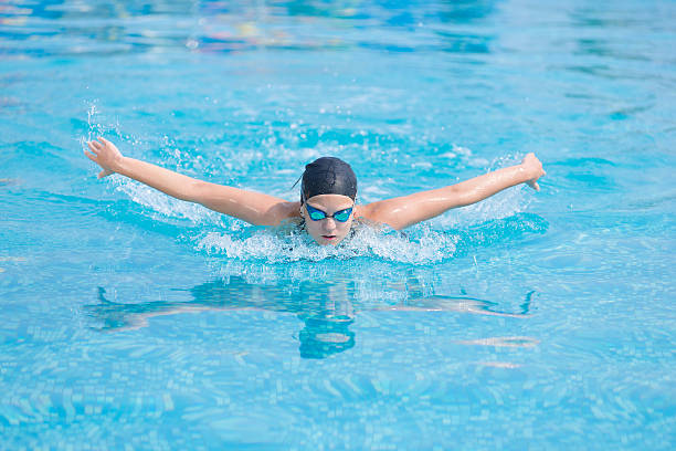 istock Young girl swimming butterfly stroke style 488509818