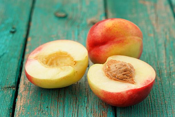 istock Two fresh ripe whole nectarines cut on vintage turquoise 488512474