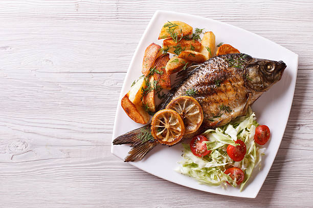 istock fried fish with fries and salad horizontal top view 488513294
