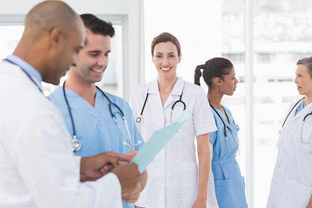 istock Smiling female doctor and her colleagues 488518966