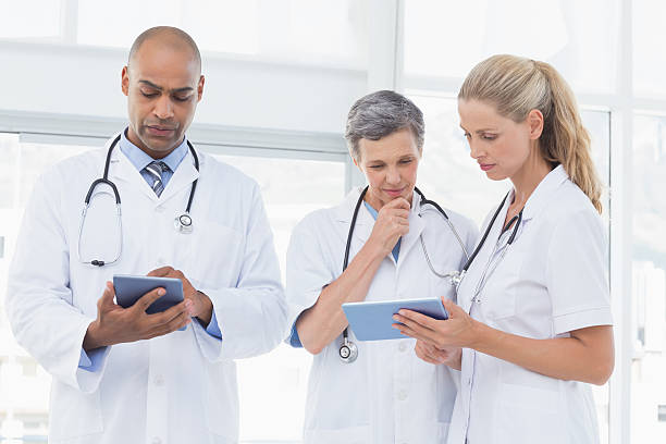 istock Team of smiling doctors working on their files 488519652