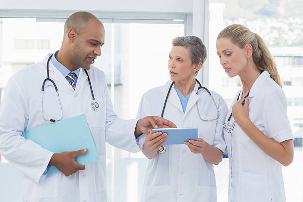 istock Team of smiling doctors working on their files 488519728