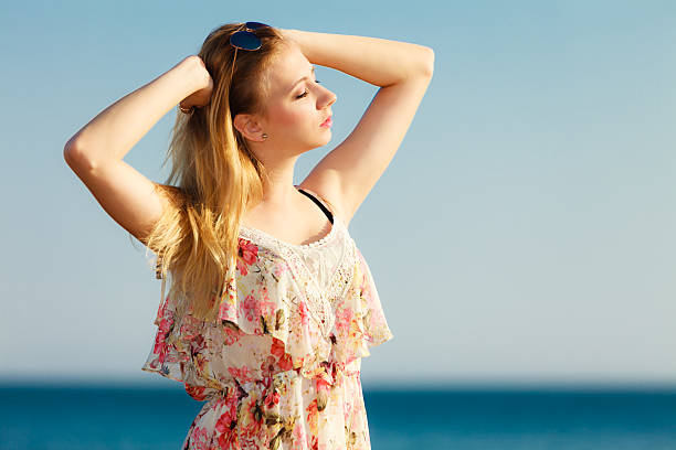 istock Summer vacation. Girl standing alone on the beach. 488520171