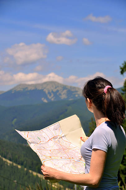 istock Girl tourist in mountain read the map. 488520714