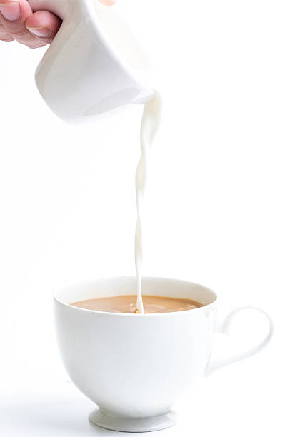 istock pouring milk in to coffee cup 488521074
