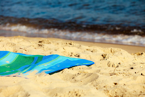 istock Summer vacation. Empty blue green mat on the beach 488521615