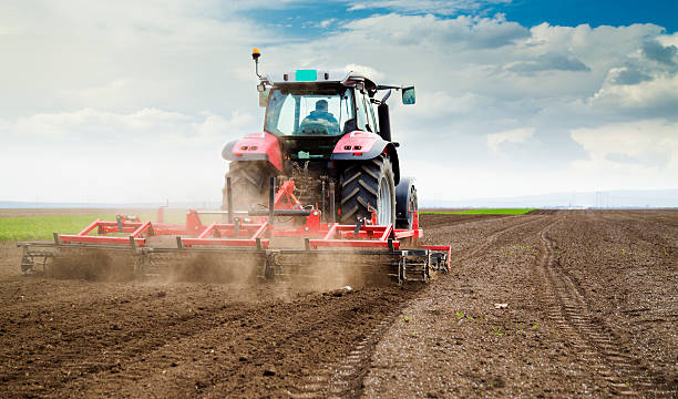 istock Farmer in tractor preparing land for sowing 488522505