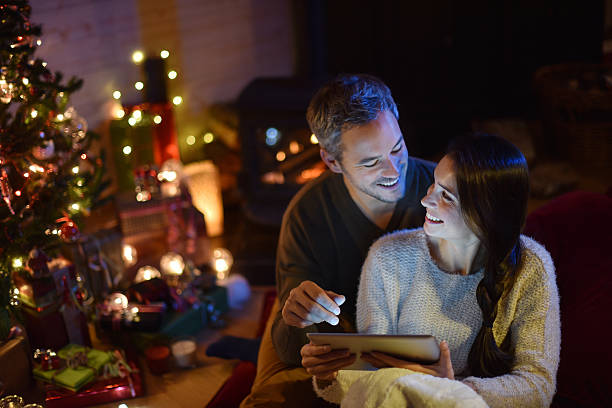 istock couple using a digital tablet at christmas eve 488524022