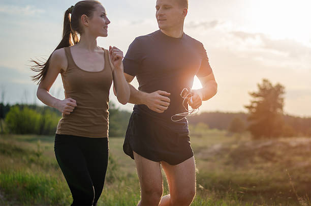 istock Young couple jogging outdoors 488524104