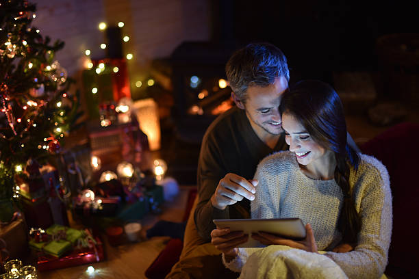istock couple using a digital tablet at christmas eve 488524324