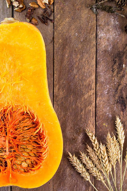 istock Halved pumpkin on wooden background 488524636