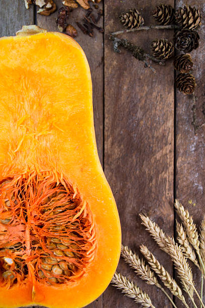 istock Halved pumpkin on wooden background 488524702