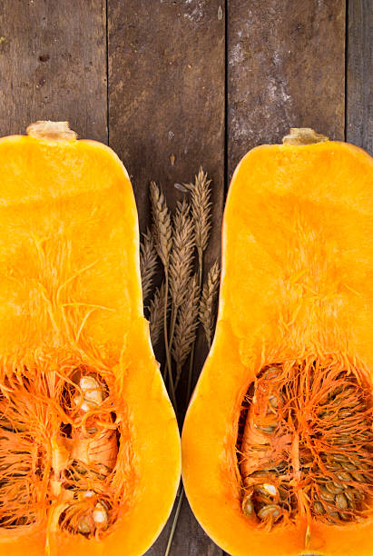istock Halved pumpkin on wooden background 488524812