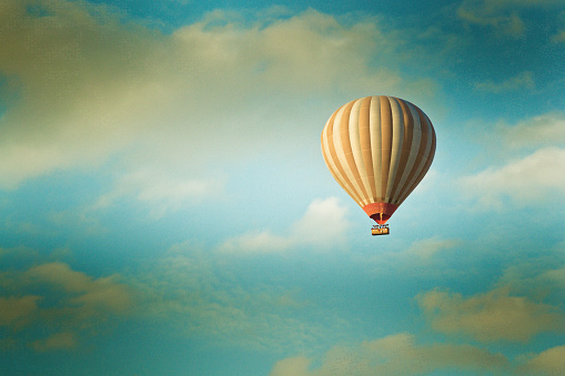 vintage hot air balloon flying in the blue sky