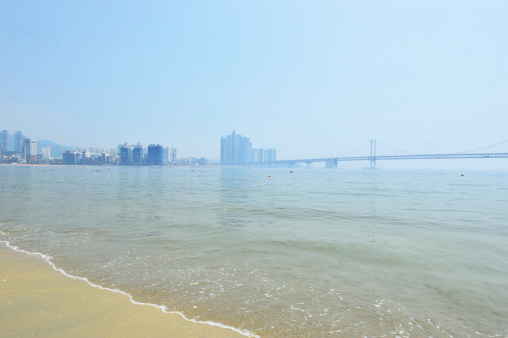 Gwangalli beach in the moring in Suyeong district in the background Diamond Bridge, Busan, South Korea