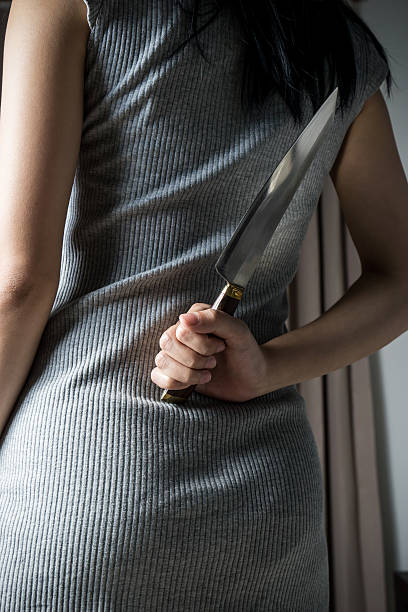 istock Holding Knife Behind Her Back , in dark tone 488526528