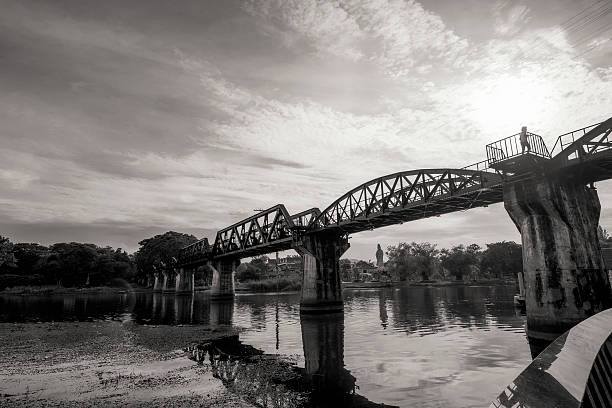 закат моста в реку квай - kwai river kanchanaburi province bridge thailand стоковые фото и изображения