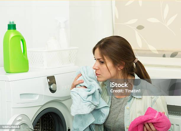 Beautiful Girl Doing Laundry Stock Photo - Download Image Now - Clothing, Smelling, Fungal Mold