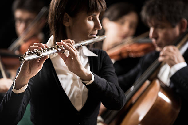 istock Classical music concert: flutist close-up 488529034