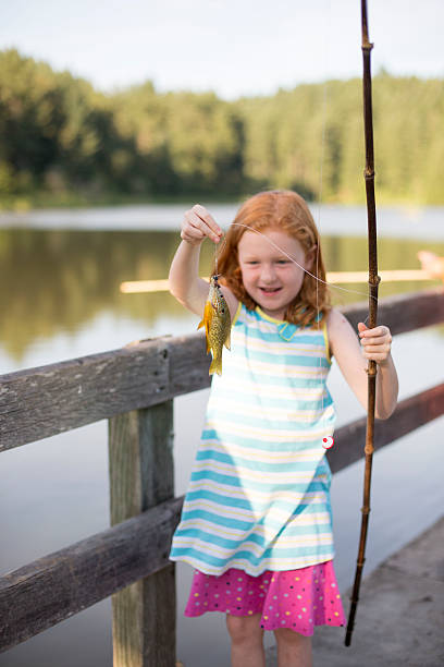 istock Young girl fishing 488529116