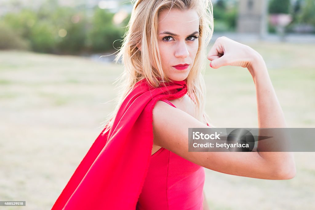 Young blonde woman looking at camera and show biceps. 2015 Stock Photo