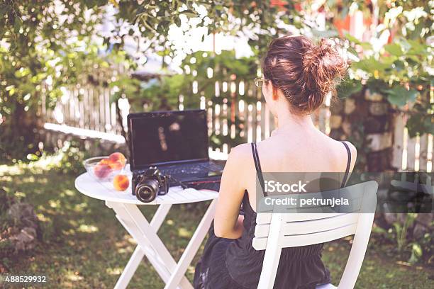 Woman In Garden Stock Photo - Download Image Now - Formal Garden, Laptop, Table