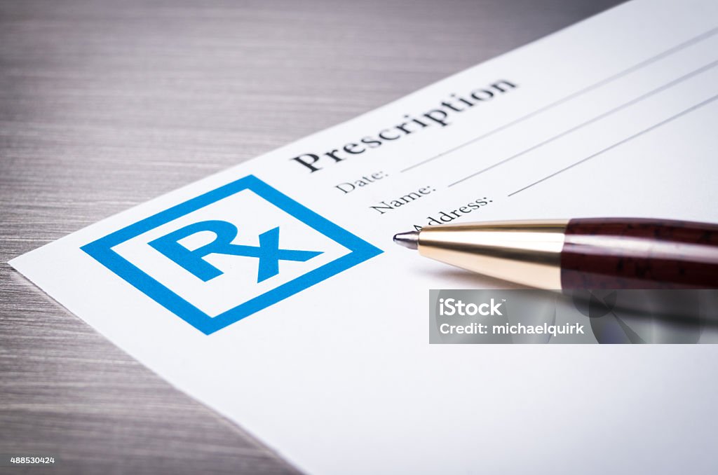 Prescription form close-up Closeup of a prescription form with a pen on a stainless steel background Prescription Stock Photo