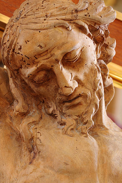 istock christ wooden statue detail 488530428