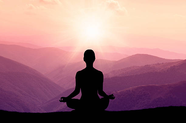 istock Yoga silhouette on the mountain in sunrays 488530898