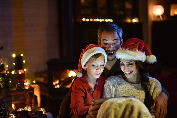 istock the night christmas, family sharing a digital tablet 488531306