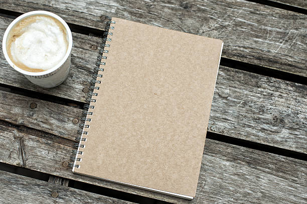 Paper notebook on wood background Paper notebook on wood background peoples alliance for democracy stock pictures, royalty-free photos & images