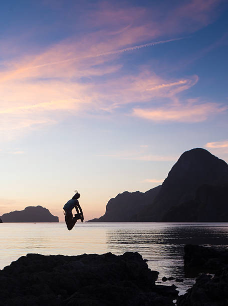 istock Man with his hands up at the sunset time 488533458