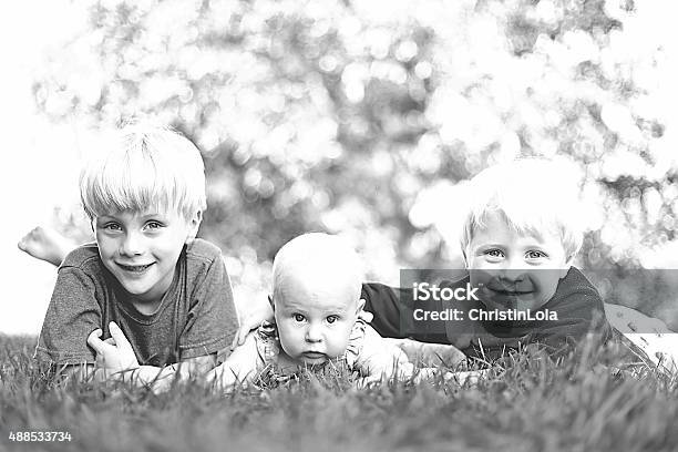 Three Happy Young Children Laughing Outside Stock Photo - Download Image Now - 12-17 Months, Baby - Human Age, Blond Hair