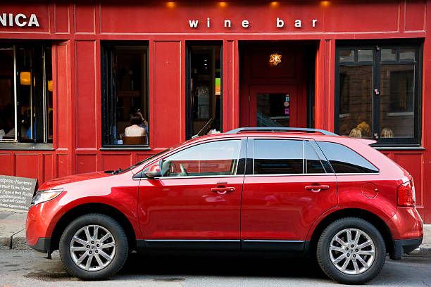Red on red Boston, MA, USA -- July 27, 2015: Red SUV car parked in front of the wine bar entrance, people are eating and drinking inside wine bar counter stock pictures, royalty-free photos & images