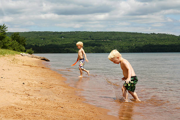istock Two Children PLaying on Beach at Lake Superior 488534364